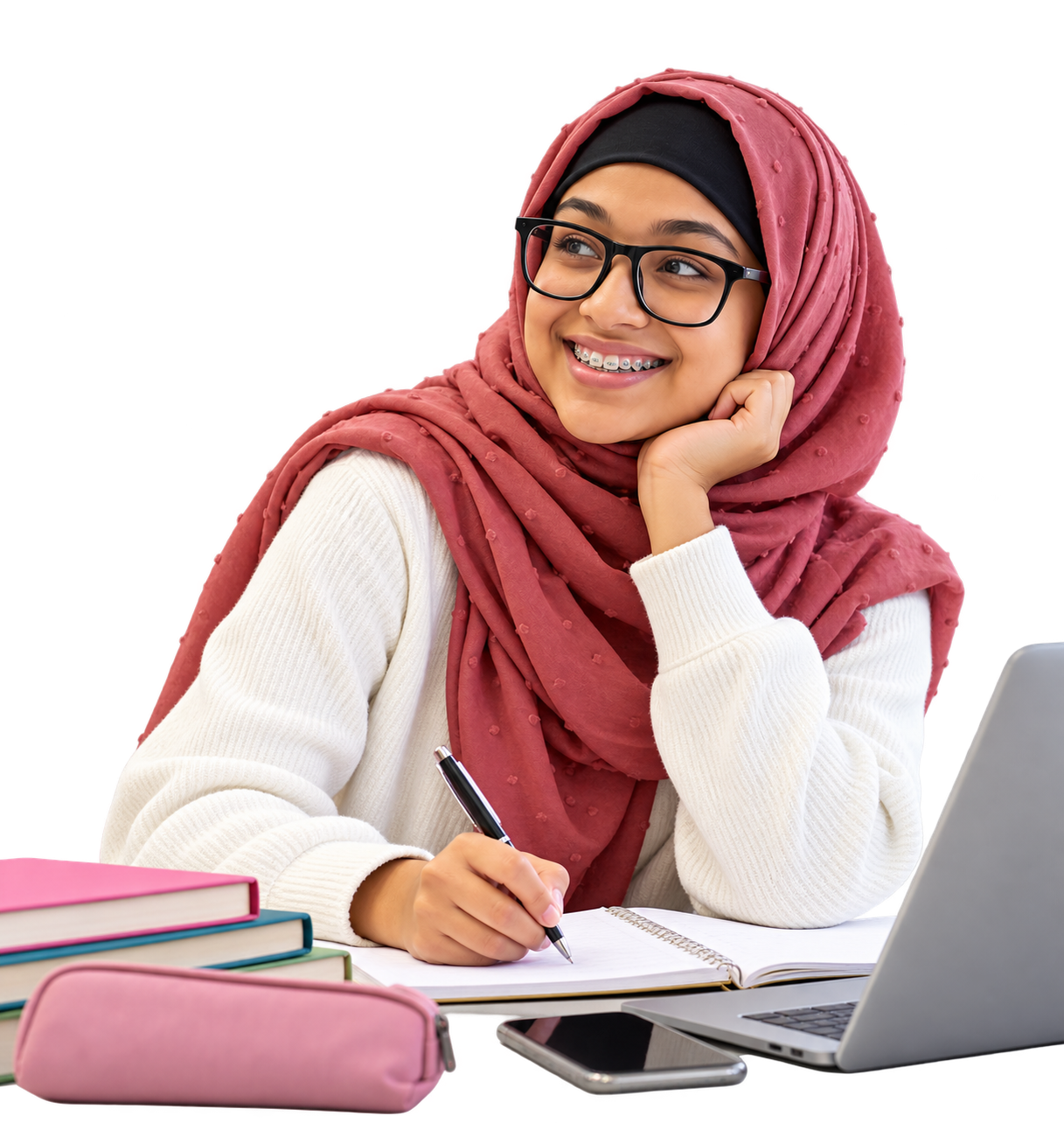 Young person writing in a notebook beside a laptop